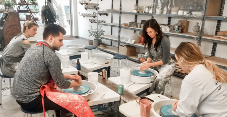 The team learning pottery at a team event